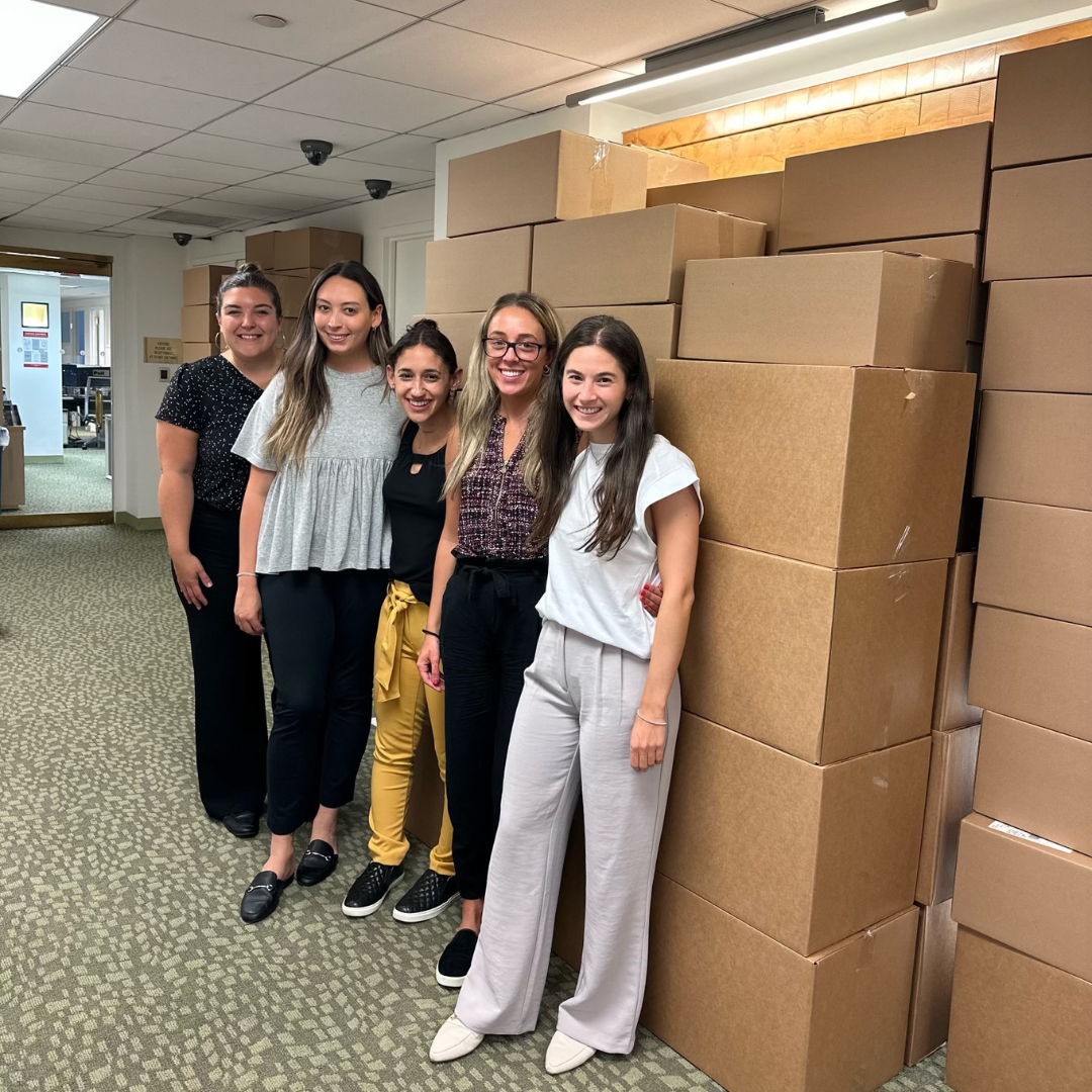 Social workers standing in front of boxes