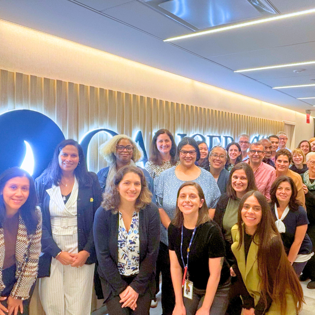 Staff posing in front of CancerCare sign
