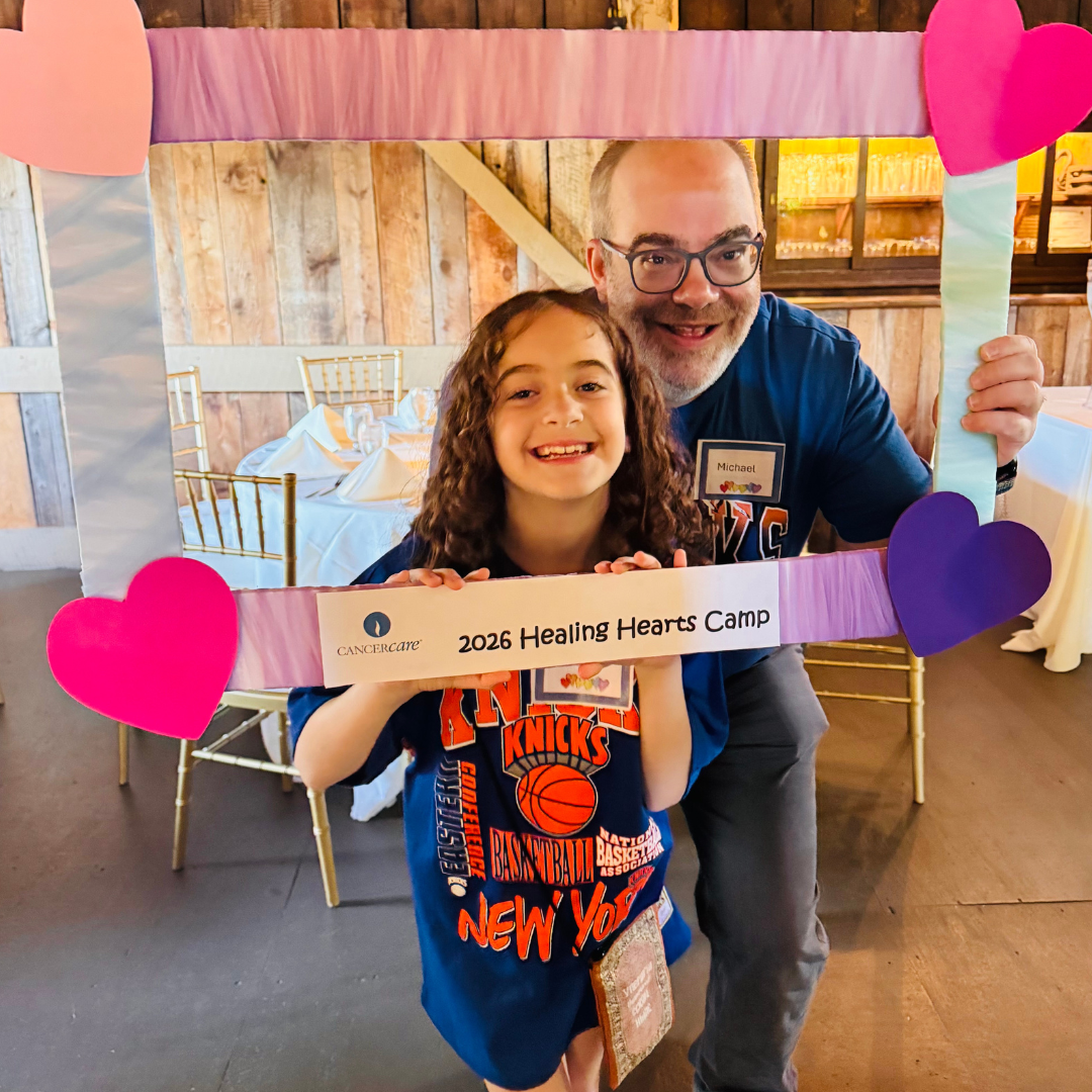 Father and daughter Healing Hearts 2026 sign