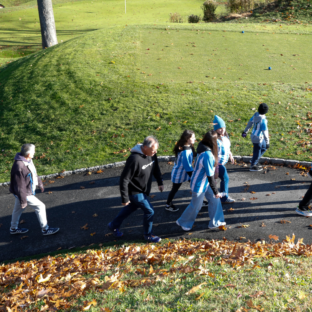 Three women standing at CancerCare table
