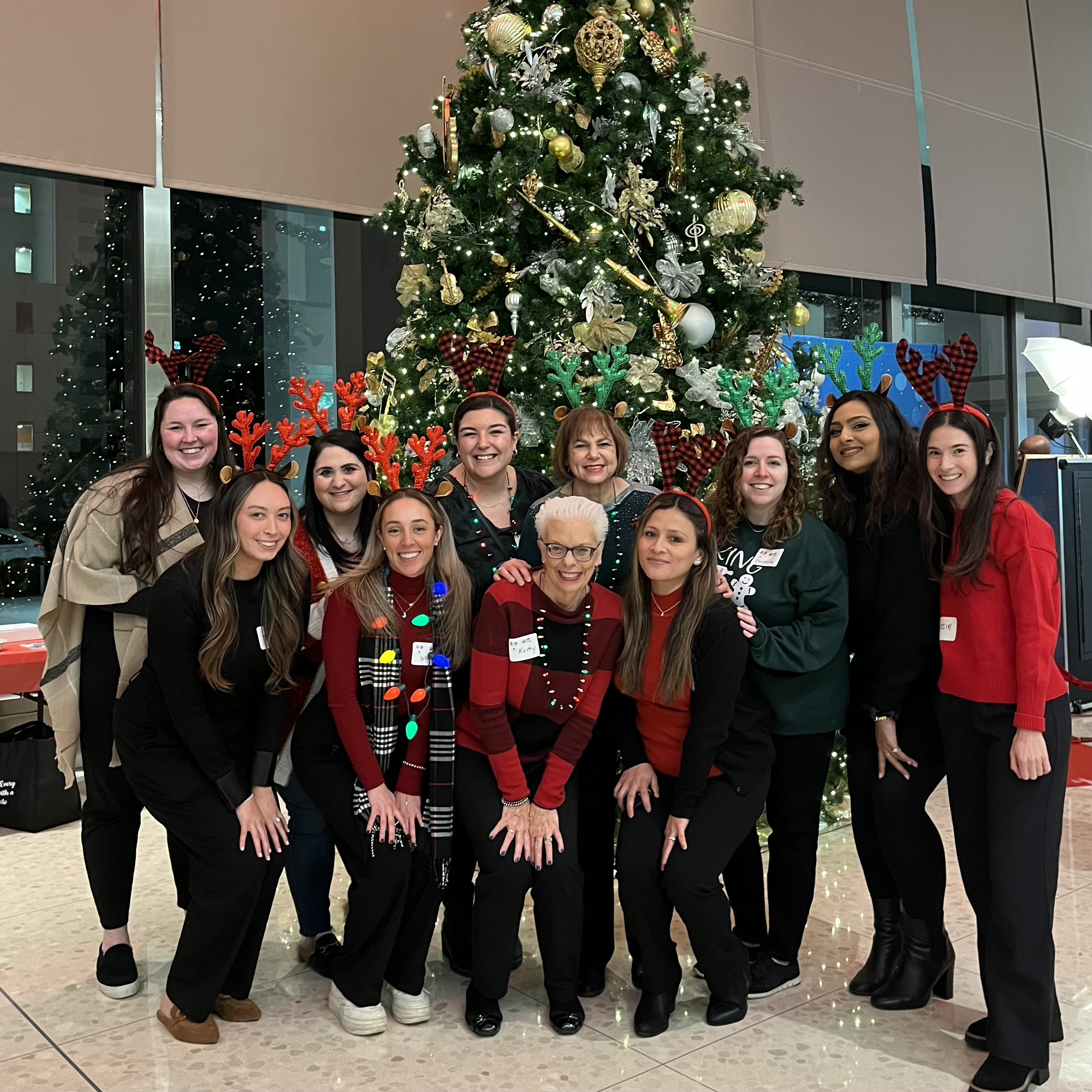 CancerCare staff standing in front of Christmas tree