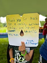 Healing Hearts camper looking through thank you note.