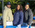 Three women standing at CancerCare table