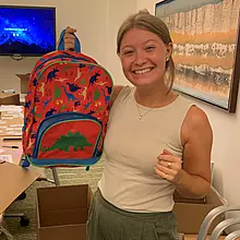Photo of a CancerCare staff member holding a backpack